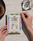 Woman holding booklet of classic family card games