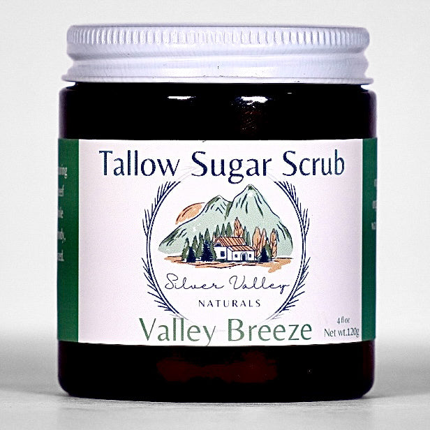 Jar of Tallow Sugar Scrub with a mountain and cabin design on the label
