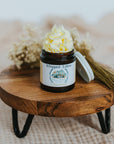 Jar of whipped cream on a wooden stand with a blurred background