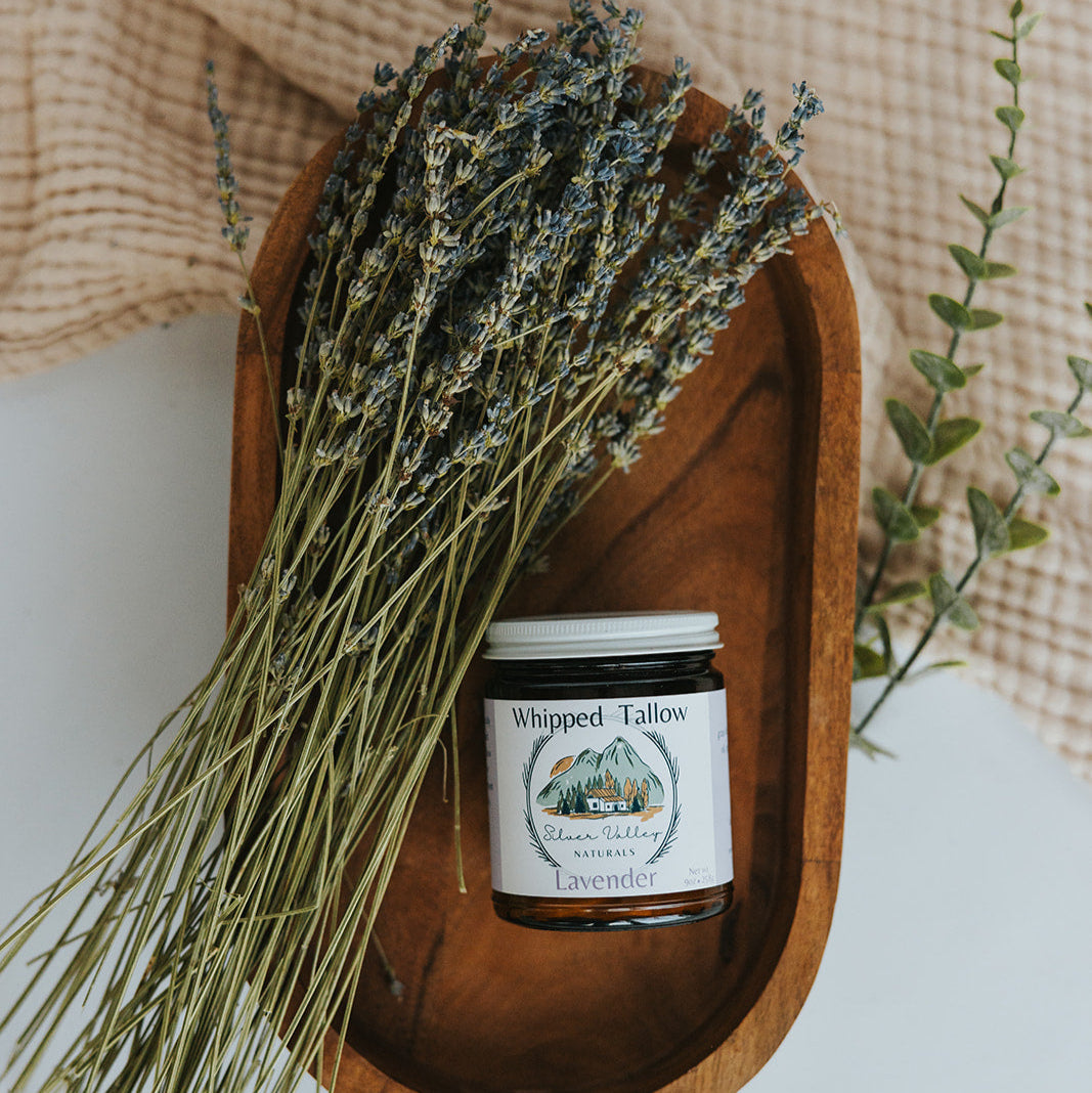 Wooden dish with a jar of 'Whipped Talloch' and lavender on a textured surface