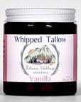 Jar of 'Whipped Tallow' vanilla product with a mountain and cabin design on the label.
