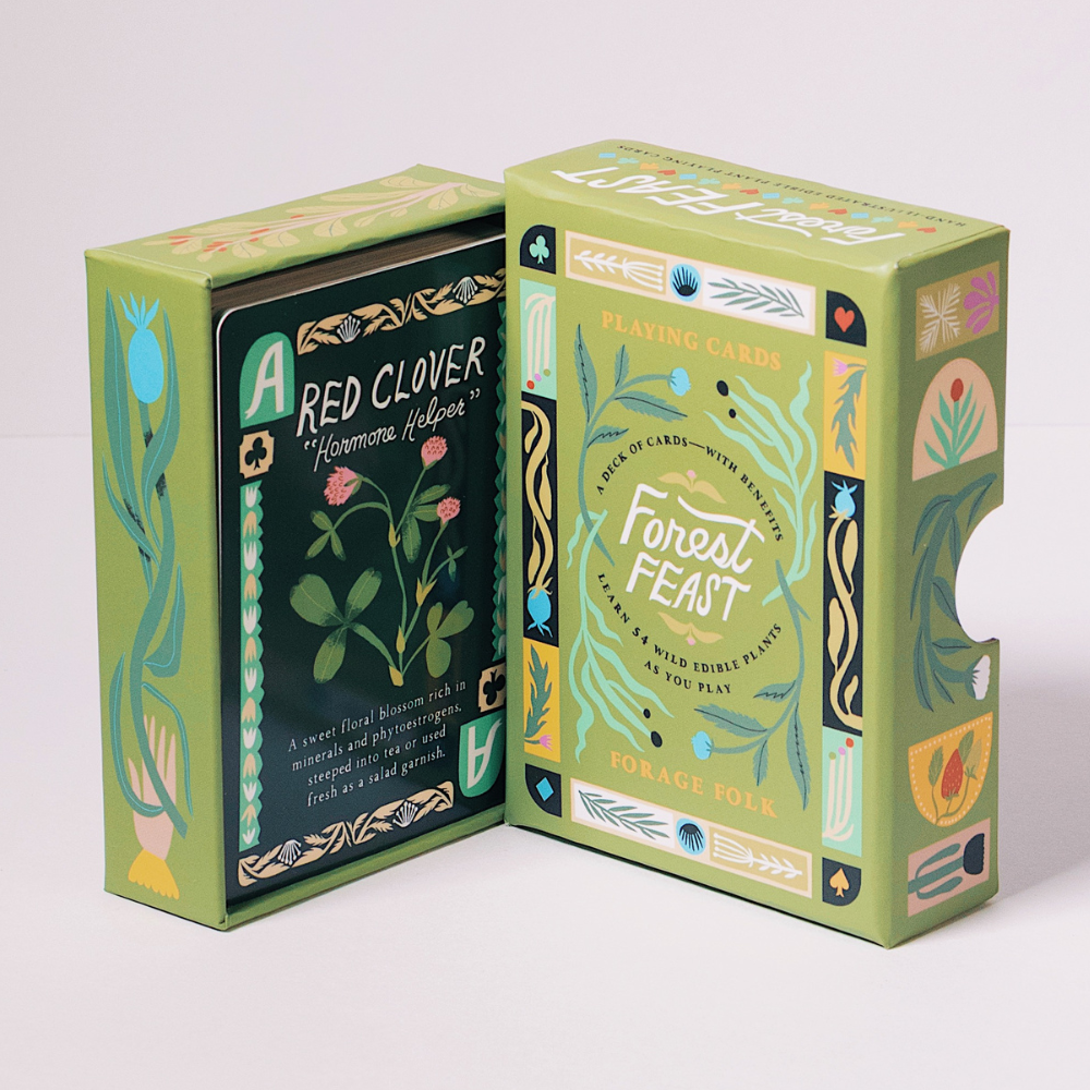 Forest Feast playing card boxes with botanical designs and foraging educational information