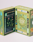 Forest Feast playing card boxes with botanical designs and foraging educational information