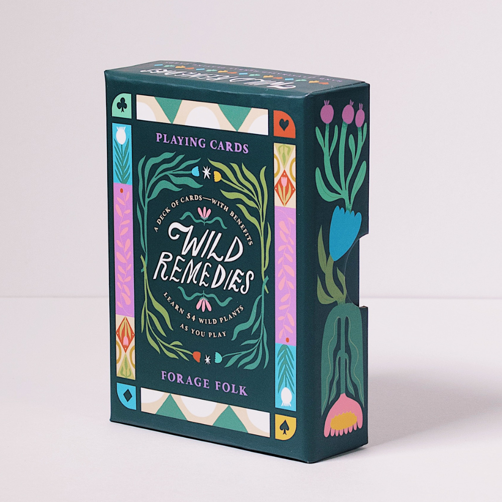Wild Remedies playing card boxes with botanical designs and herbal educational information