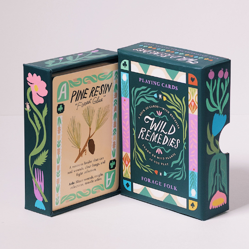 Wild Remedies playing card boxes with botanical designs and herbal educational information