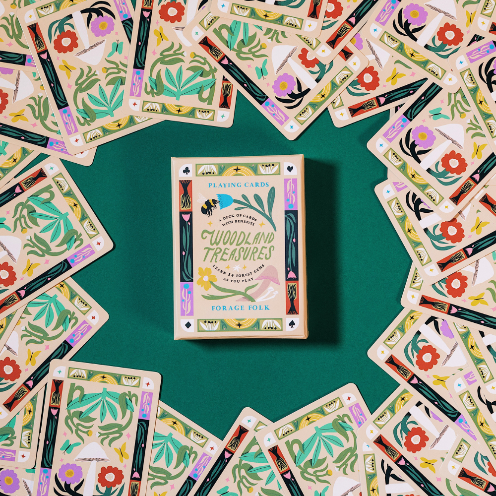 Card game Woodland Treasures box surrounded by assorted illustrated cards