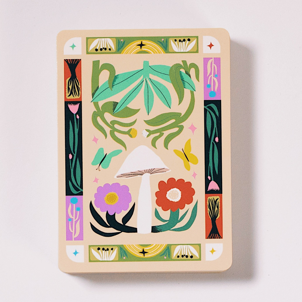 Illustrated playing card back with nature-themed design for Wooland Treasures deck