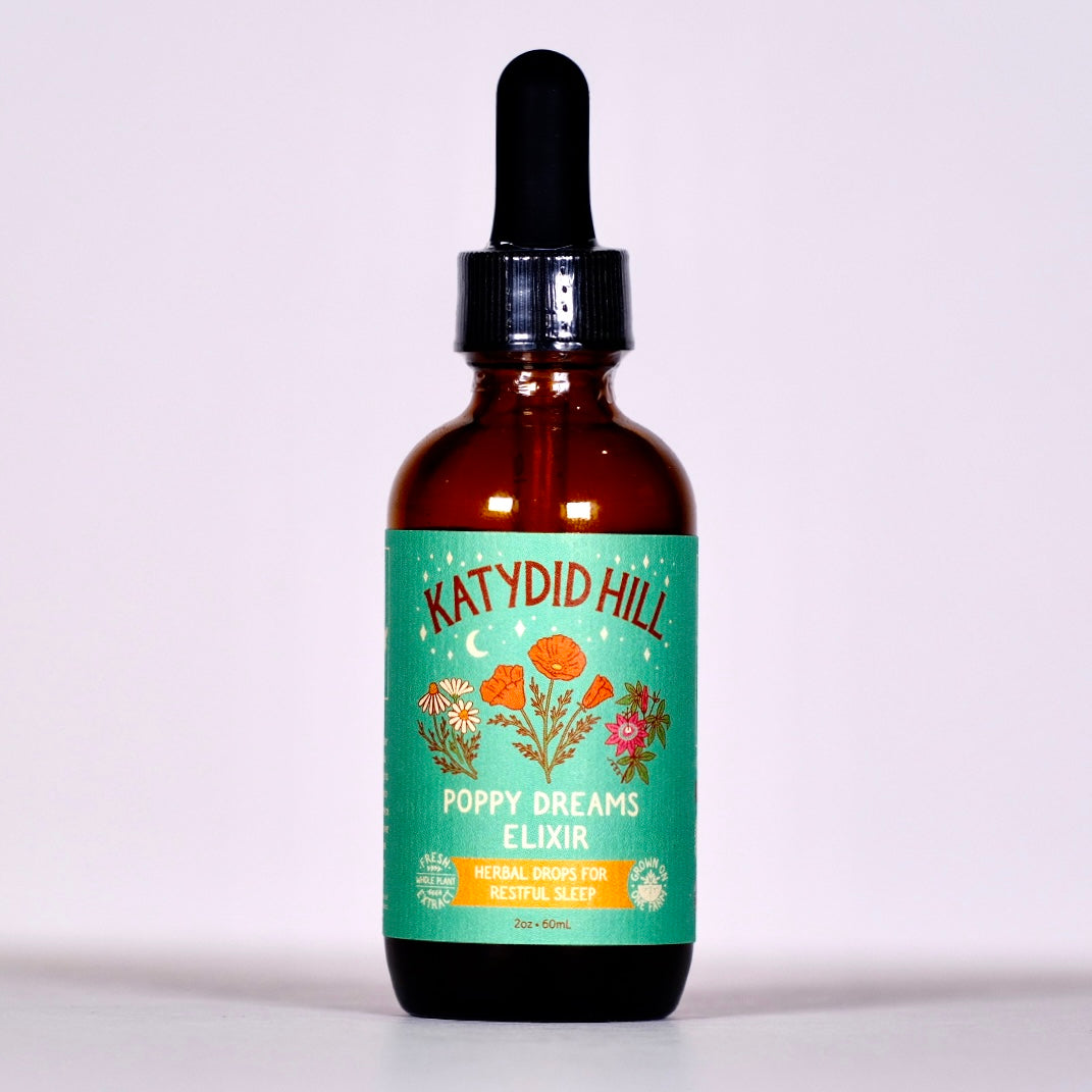 Bottle of Katydid Hill Poppy Dreams Elixir on a light purple background