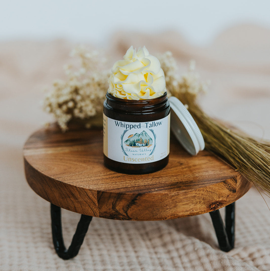 Jar of whipped cream on a wooden stand with a blurred background