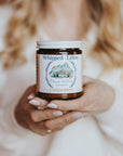 Person holding a jar of 'Whipped Talons' against a brick wall background